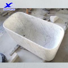 rectangular white marble bathtub